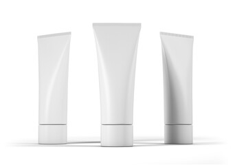 Three white tubes of makeup sit on a white background