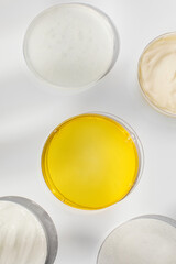 Antiaging cosmetic products in Petri dishes in white table