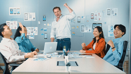 Diverse business team celebrate successful project by clapping hands and raising arm in the air. Group of happy corporate businesspeople smiling while sitting in business meeting. Manipulator.