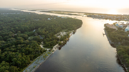 Aerial view of Snow's Cut waterway leading to the Atlantic Ocean, bordered by dense forests and a...