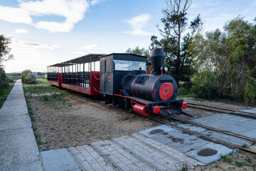 Retro train that transports visitors from the mainland to the Barril beach near Tavira, Portugal.