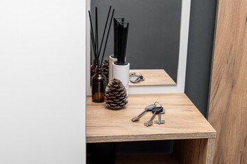 House keys in wooden anteroom. Accessories in the hallway