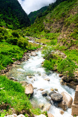 A stormy mountain river and large stone boulders.  The North Caucasus. Russia