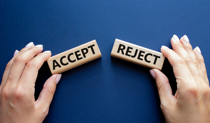 Accept or Reject symbol. Concept word Accept or Reject on wooden blocks. Businessman hand. Beautiful deep blue background. Business and Accept or Reject concept. Copy space