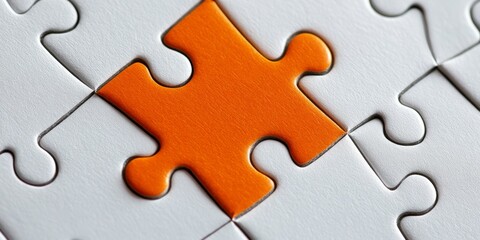 Fototapeta premium A solitary orange puzzle piece seamlessly fits into a vast sea of uniform white pieces, symbolizing individuality