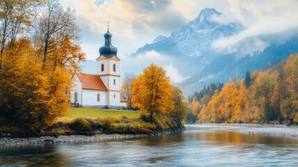 Fototapeta premium Gorgeous scenery found in nature. Amazing view in October. Beautiful mountain scenery found in the Bavarian Alps. quaint little church beside the river.viewpoint of the well-known St. Sebastian Parish