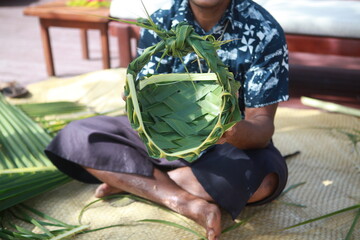 Fijian traditional basket weaving from palm leaves, men's basket demonstration, Fiji