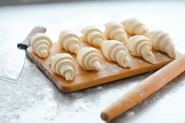 raw mini homemade French butter croissants on baking tray