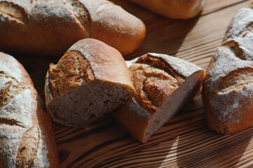 Freshly baked sourdough bread with a golden crust on bakery shelves. Baker shop context with delicious bread