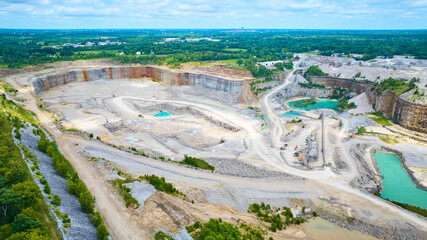 Aerial View of Quarry and Green Landscape with Construction Vehicles