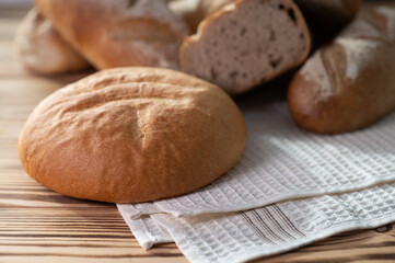 Freshly baked sourdough bread with a golden crust on bakery shelves. Baker shop context with delicious bread