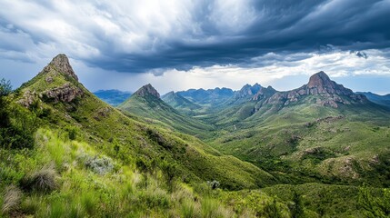 Naklejka premium A panoramic view of lush mountains under a dramatic sky, showcasing nature's beauty.