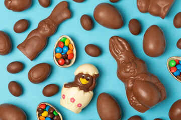Easter chocolate egg. Easter celebration concept. Happy Easter. Chocolate sweet eggs. Candies on textured wooden table. Space for text.Copy space