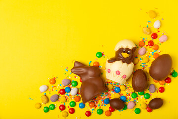 Easter chocolate egg. Easter celebration concept. Happy Easter. Chocolate sweet eggs. Candies on textured wooden table. Space for text.Copy space