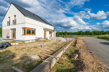 Wooden faming filled with concreted. New build house fence under construction