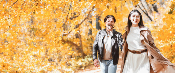Emotional young man and woman running in sunlight of autumn forest, holding hands