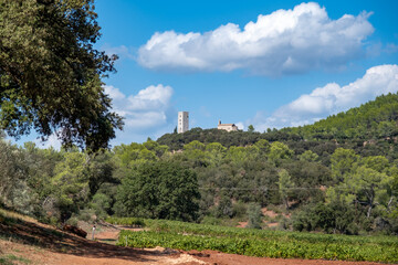 view on medieval tower and church on hills in the French Riviera back country in late summer