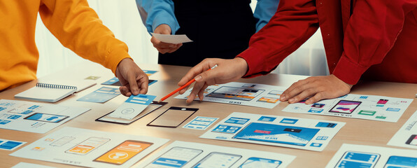 Panorama banner of startup company employee planning on user interface prototype for mobile application or website in office. UX UI designer brainstorm user friendly interface plan. Synergic