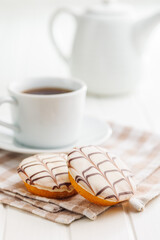 Sweet dessert with sugar coating on white table.