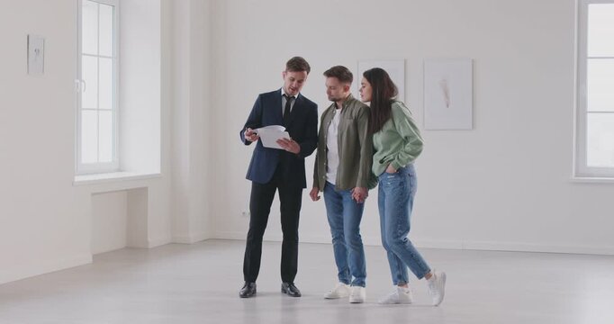 happy couple and a real estate agent inspecting a new house for potential purchase or rent. The couple explores the property with the agent, evaluating its suitability as new home.