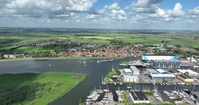 Makkum, village in Friesland, along the Ijsselmeer, industrial port with lagre ship builder. Aerial drone view.