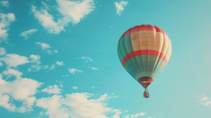 Naklejka premium Colorful Hot Air Balloon Flies Against A Blue Sky