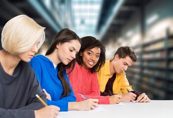 Group of teenage happy students study in classroom library