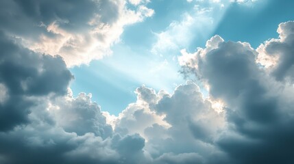 A serene sky filled with clouds and rays of sunlight breaking through.