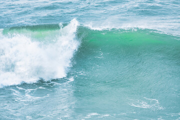 Wave splashing close-up. Crystal clear sea water, in the ocean in San Francisco Bay, blue water, pastel colors.