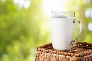 A glass of fresh tasty milk on table