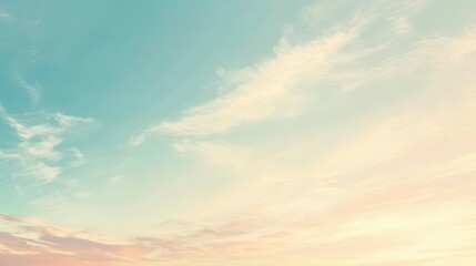 Obraz premium A serene sky with soft clouds and pastel colors at dawn or dusk.