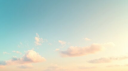 Obraz premium A serene sky with soft clouds in pastel colors during sunrise or sunset.