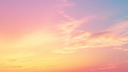Fototapeta premium A serene sunset sky with soft pink and orange hues blending into blue.