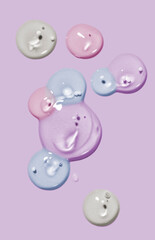 Multicolored cosmetic serum oil gels gray background isolated