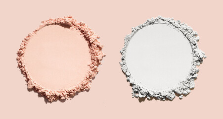 Cosmetic compact loose mattifying pressed powder isolated on beige background. Two colored samples: nude beige and white