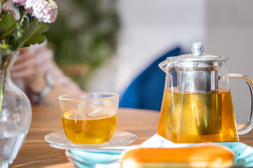 A tea set with a teapot and a cup of tea on a table