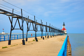 Obraz premium Lighthouse and Pier with Overhead Walkway Perspective