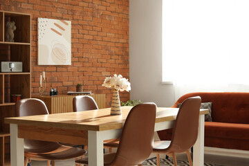 Living room in loft style with sofa, table and chairs