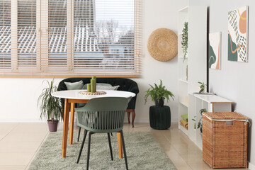 Modern stylish living room with table, black sofa and chairs