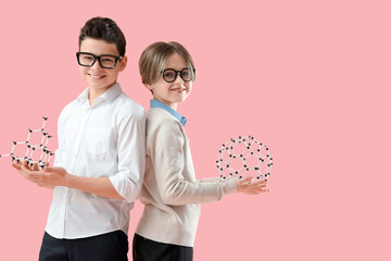 Happy brothers with molecular models on pink background