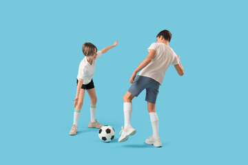 Happy brothers playing football on blue background