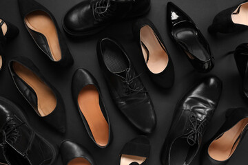 Different shoes on black background. Top view