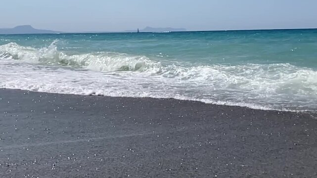 foaming waves crash noisily against the shore, the sounds of one wave on top of another can be heard