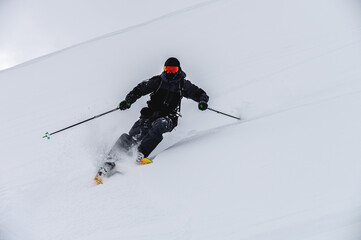 Skier man in action. Front view. Fast descent at high speed. Skier on skis in high mountains....