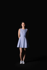 Portrait of pretty young woman on black background