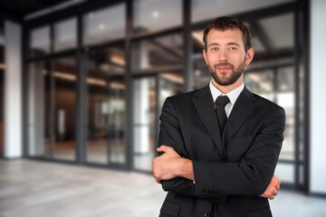 Happy professional businessman posing in office