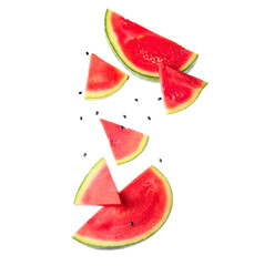 Flying pieces of fresh watermelon and seeds on white background