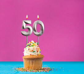 Cupcake with birthday candle number 50 - Anniversary card on blue and violet background