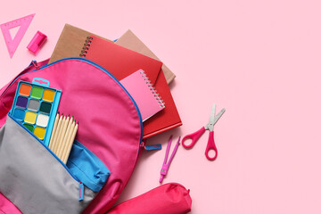 Modern school backpack with different stationery supplies on pink background
