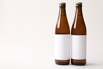 Bottles of cold beer on white background